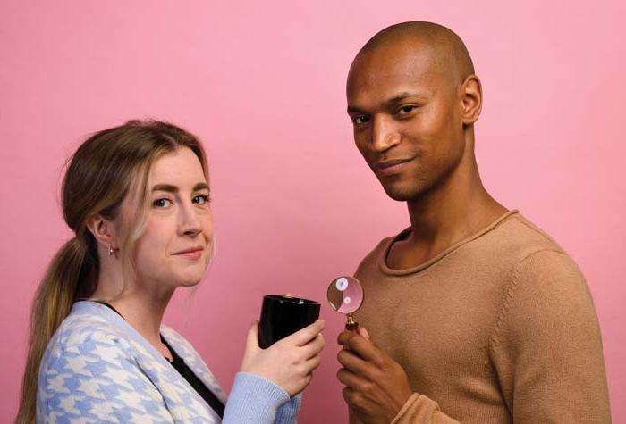 Photo of Griff Stark-Ennis ’14 and Ceara O’Sullivan ’14 holding a magnifying glass and a mug